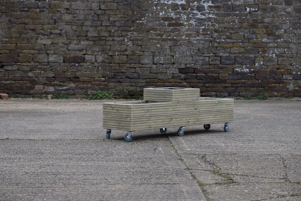 Small wooden planter on castor wheels