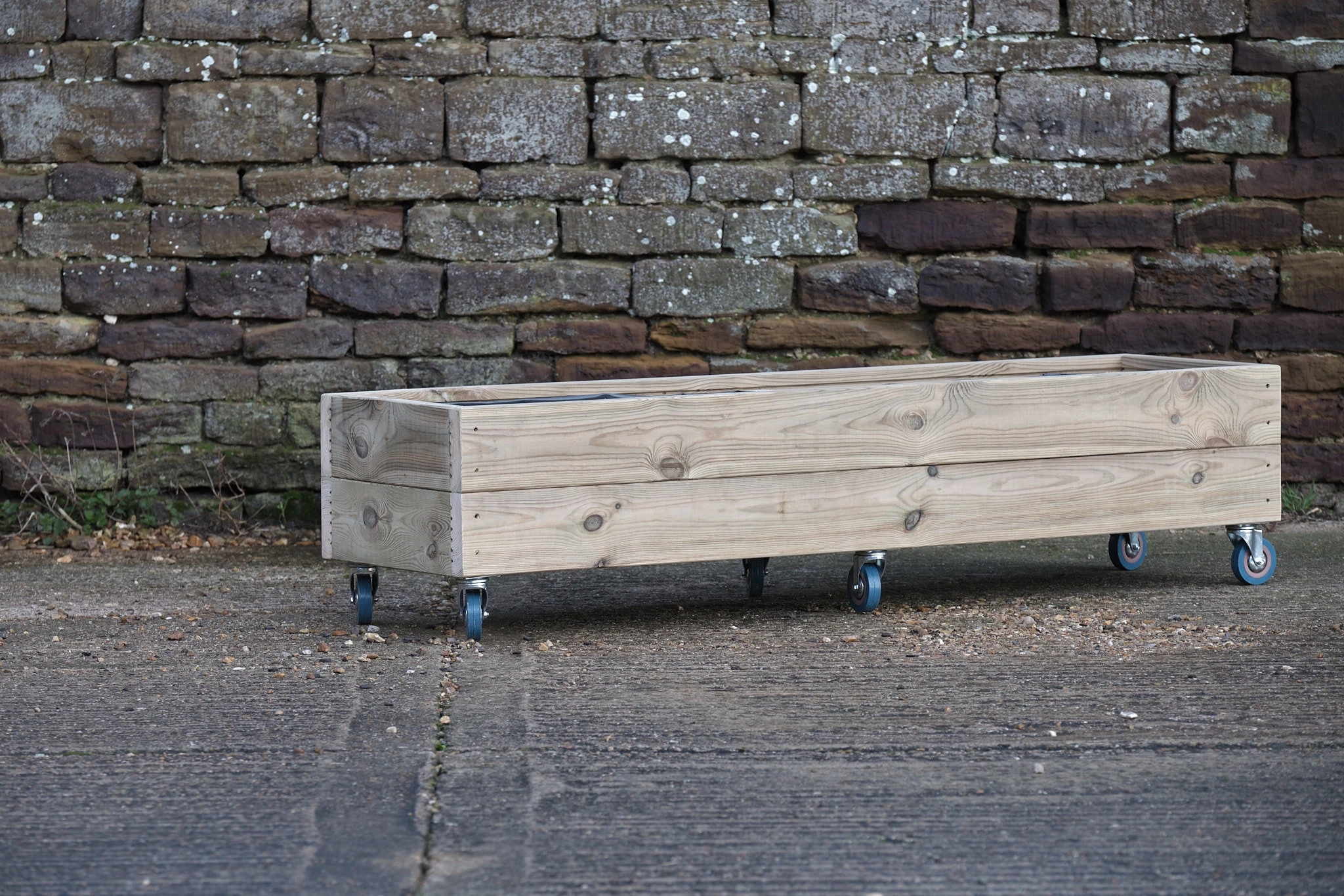 Wooden planter on wheels with trellis