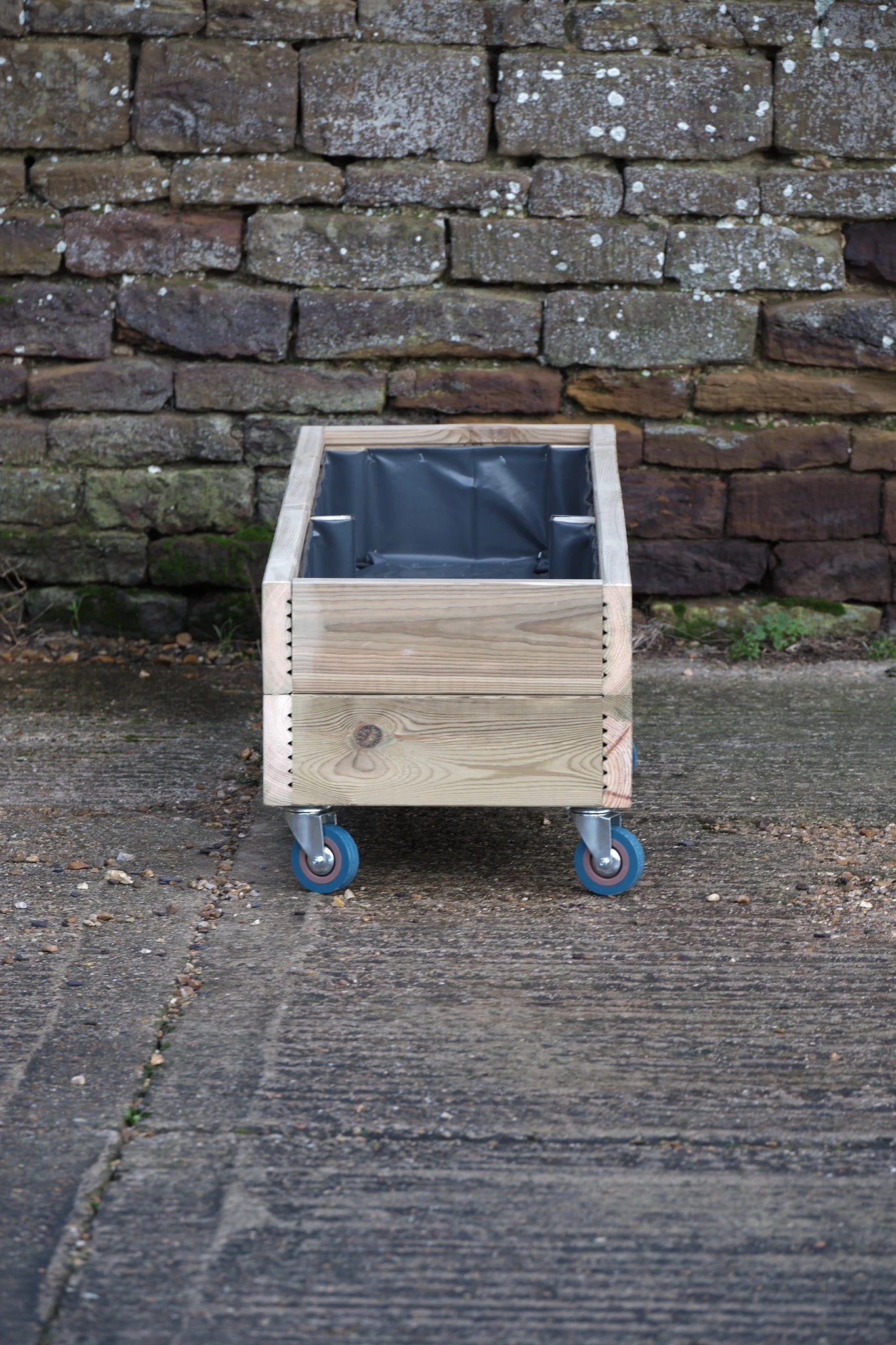 Large rectangular wooden planter on castor wheels